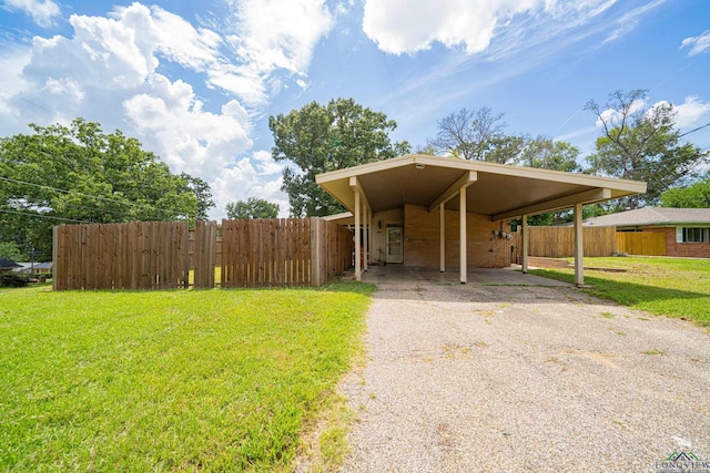 view of front facade with a front lawn and a carport