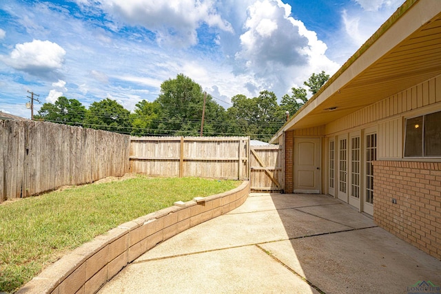 view of yard with a patio area and french doors