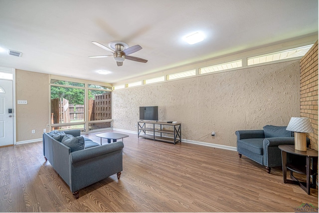 living room featuring ceiling fan and hardwood / wood-style flooring