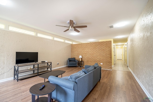 living room featuring hardwood / wood-style floors and ceiling fan