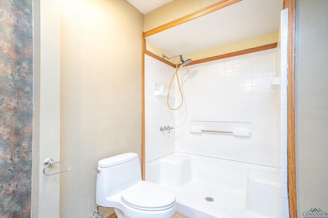 bathroom featuring walk in shower and toilet