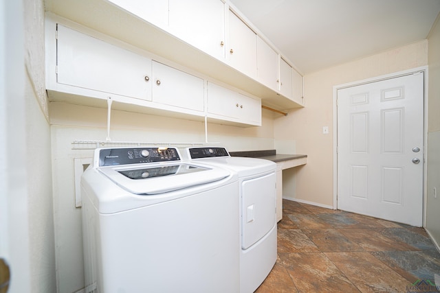 laundry room with washer and clothes dryer and cabinets