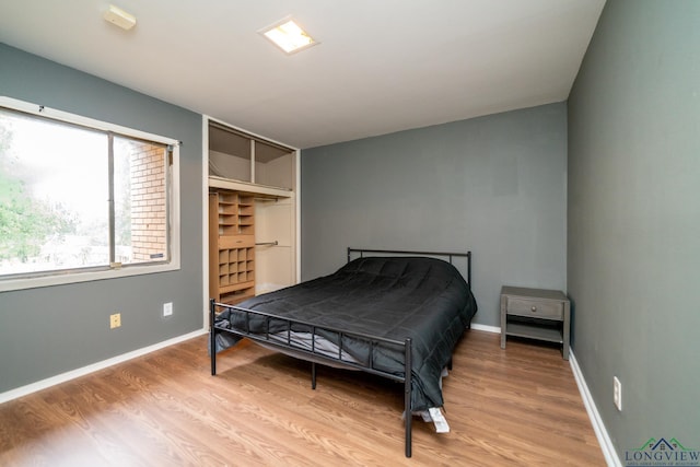 bedroom featuring light hardwood / wood-style flooring and a closet