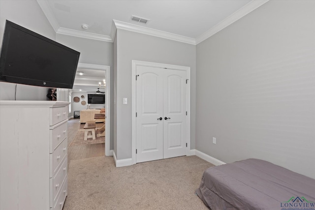 223 Circle Ridge Dr, Gilmer, TX 75645 - bedroom with crown molding, light colored carpet, a closet, and baseboards