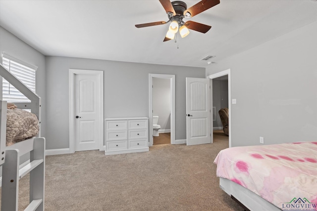 223 Circle Ridge Dr, Gilmer, TX 75645 - bedroom with light colored carpet, baseboards, connected bathroom, and ceiling fan