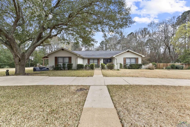 single story home with fence and a front lawn