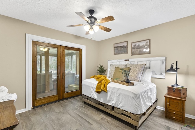 bedroom with a textured ceiling, ceiling fan, wood finished floors, baseboards, and access to exterior