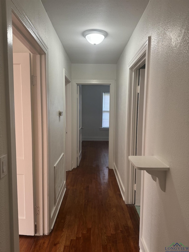 hall featuring dark wood-type flooring