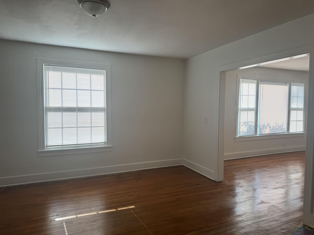 empty room featuring dark hardwood / wood-style flooring