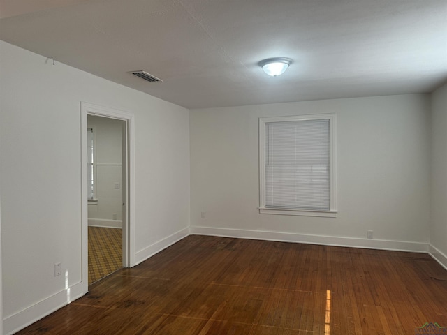 spare room with dark hardwood / wood-style flooring