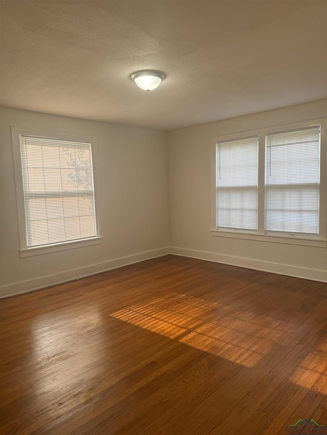 spare room featuring dark wood-type flooring