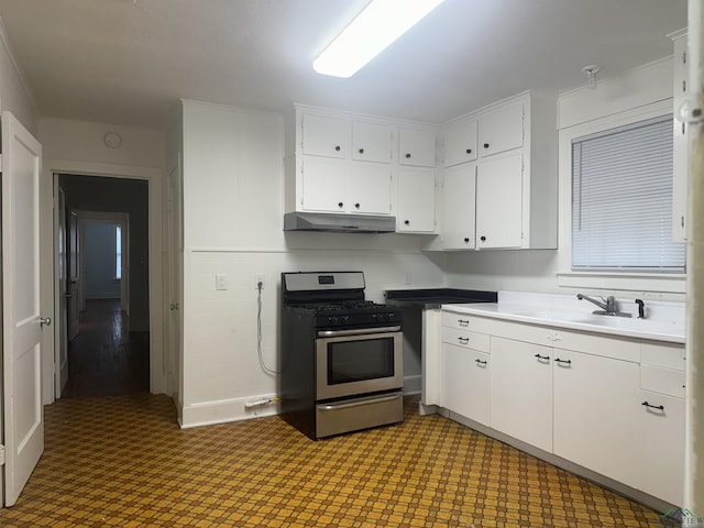 kitchen featuring white cabinets, stainless steel gas stove, and sink