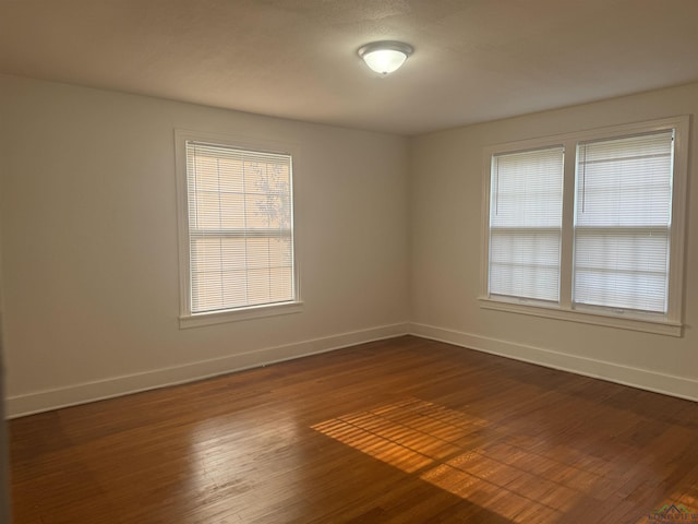 empty room with dark hardwood / wood-style floors