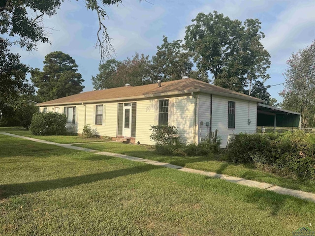 single story home featuring a front yard and a carport