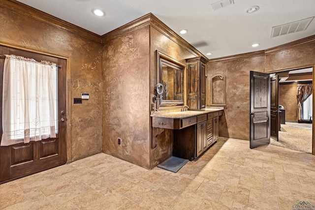 kitchen with ornamental molding, visible vents, and dark brown cabinets