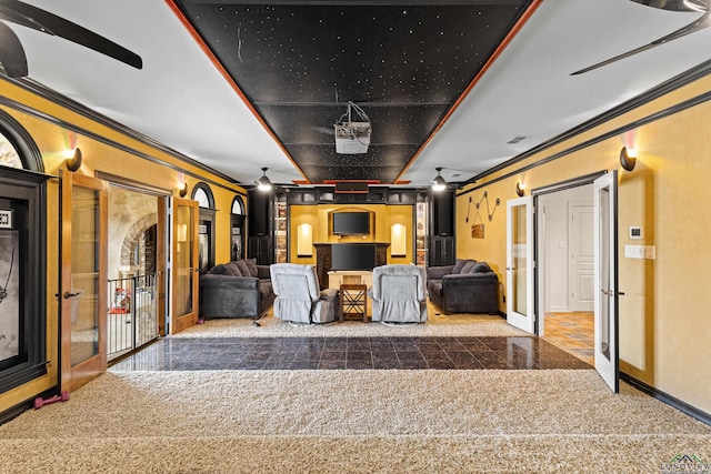 cinema with carpet, baseboards, and crown molding