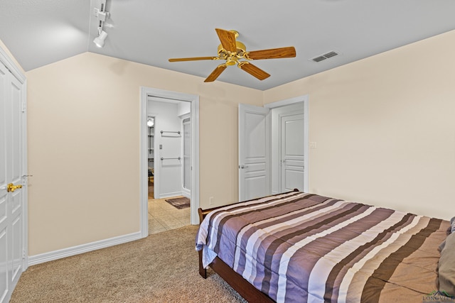 bedroom with lofted ceiling, light colored carpet, visible vents, a ceiling fan, and track lighting