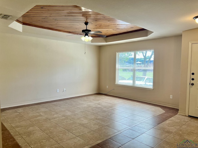 spare room featuring light tile patterned floors, a raised ceiling, ceiling fan, and wooden ceiling