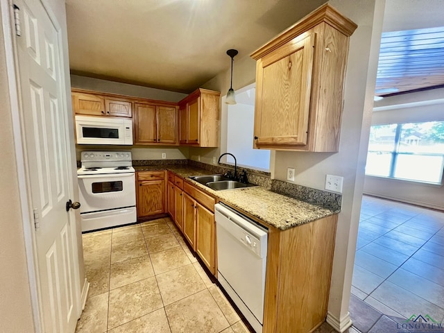 kitchen with pendant lighting, white appliances, stone counters, sink, and light tile patterned floors