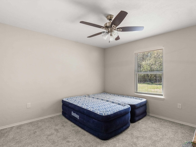 bedroom with carpet flooring, a ceiling fan, and baseboards