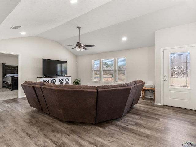 living area featuring visible vents, a ceiling fan, wood finished floors, recessed lighting, and lofted ceiling