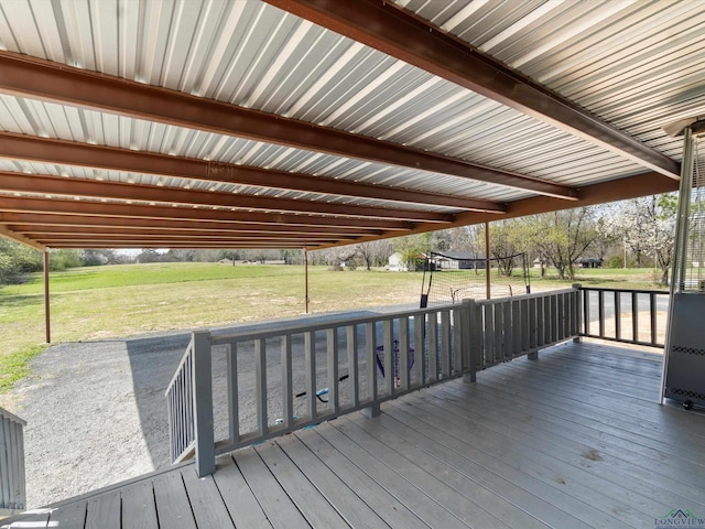 wooden terrace featuring a yard