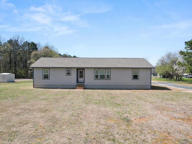 ranch-style house with entry steps and a front lawn