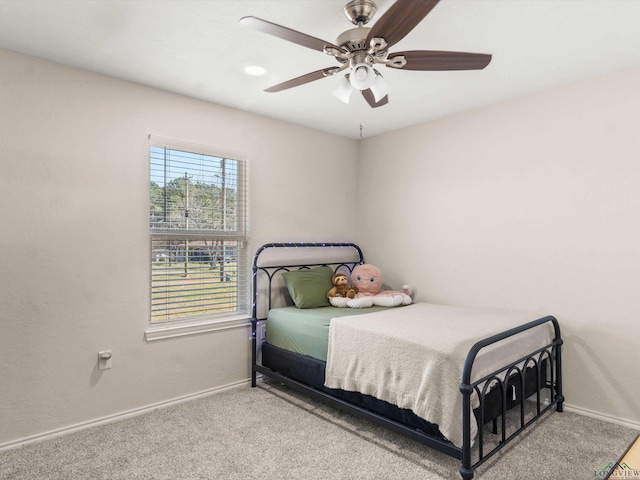 bedroom with ceiling fan, baseboards, and carpet