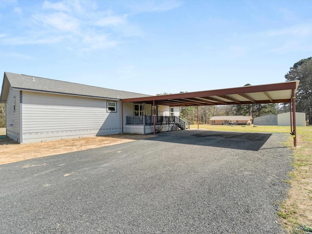 view of vehicle parking with an attached carport and driveway