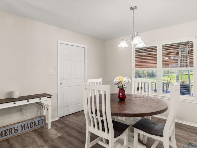 dining area with a notable chandelier, baseboards, and wood finished floors