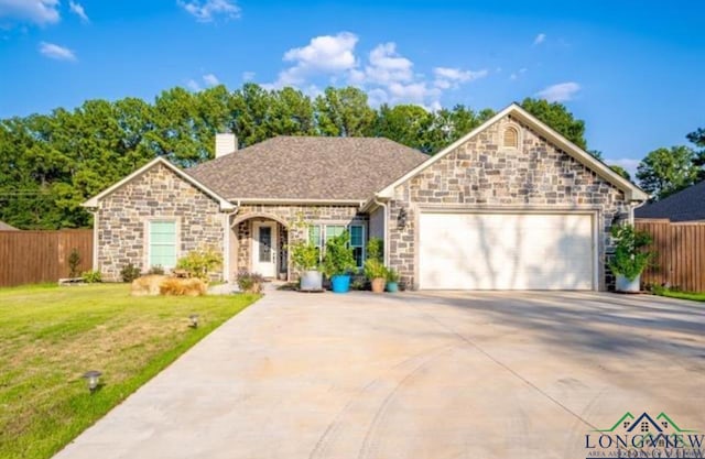 view of front of property featuring a front yard and a garage