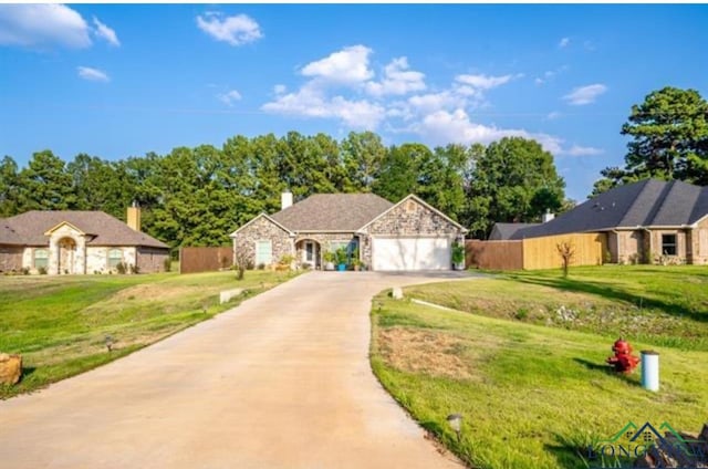 ranch-style home featuring a front lawn and a garage