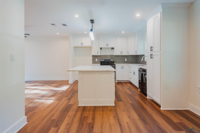 109 Montie St, Longview, TX 75604 - kitchen featuring a kitchen island, black dishwasher, decorative backsplash, light wood-style flooring, and stainless steel electric range
