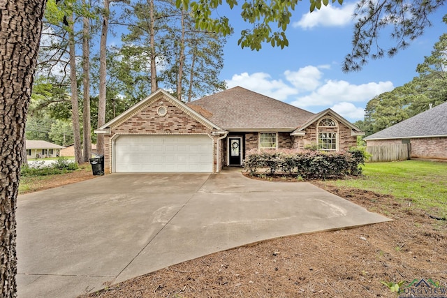 801 NW Dr, Longview, TX 75604 - view of front of home featuring brick siding, a garage, concrete driveway, a shingled roof, and a front lawn