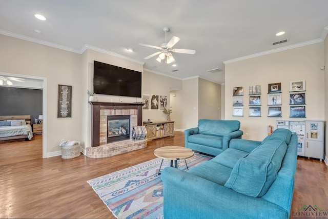 801 NW Dr, Longview, TX 75604 - living area featuring ceiling fan, recessed lighting, ornamental molding, wood finished floors, and a brick fireplace