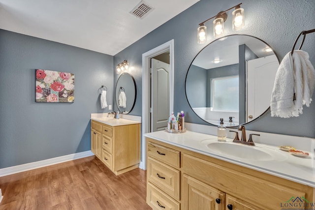801 NW Dr, Longview, TX 75604 - full bath with two vanities and wood finished floors