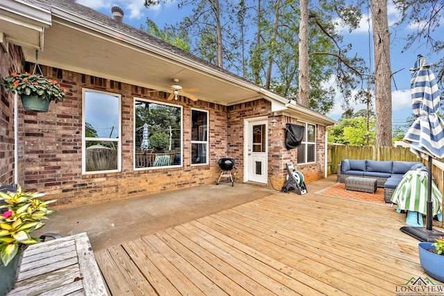 801 NW Dr, Longview, TX 75604 - wooden terrace with an outdoor hangout area, a fenced backyard, a ceiling fan, and a patio area