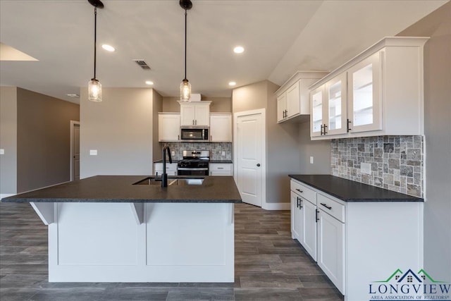 kitchen with white cabinetry, an island with sink, appliances with stainless steel finishes, pendant lighting, and sink