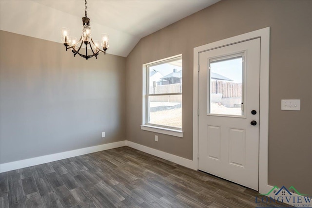 interior space featuring vaulted ceiling, dark hardwood / wood-style floors, and a chandelier