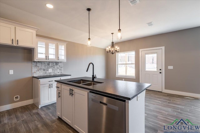 kitchen with white cabinets, dishwasher, decorative light fixtures, an island with sink, and sink