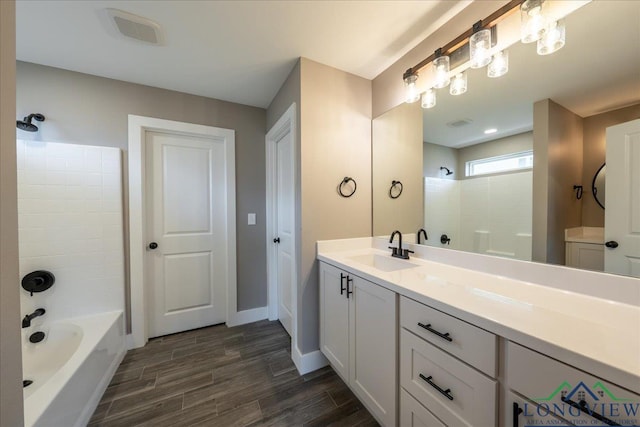 bathroom with tub / shower combination and vanity