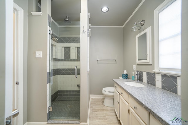 bathroom featuring tile patterned floors, ornamental molding, vanity, a shower with door, and toilet