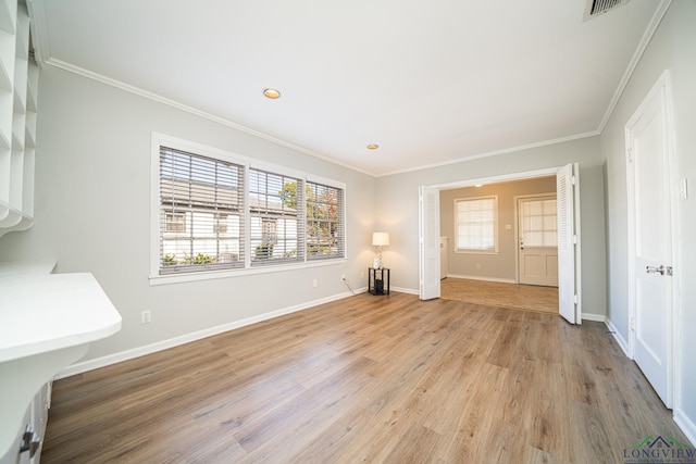 interior space featuring crown molding and light wood-type flooring