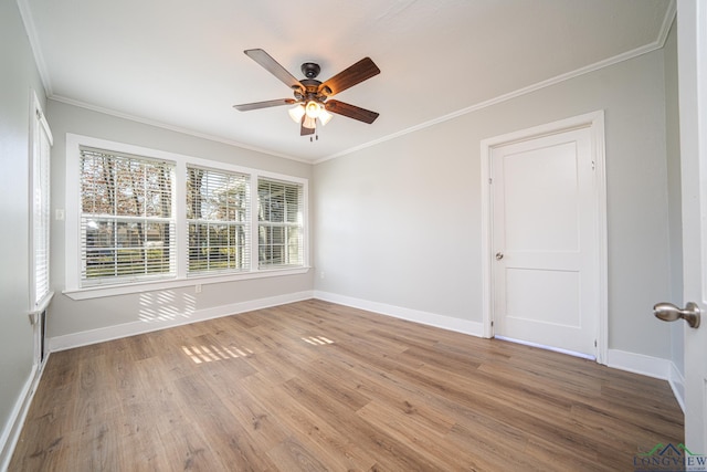 empty room featuring ceiling fan, ornamental molding, and light wood-type flooring