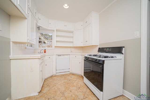 kitchen with white cabinetry, tile counters, crown molding, and white appliances