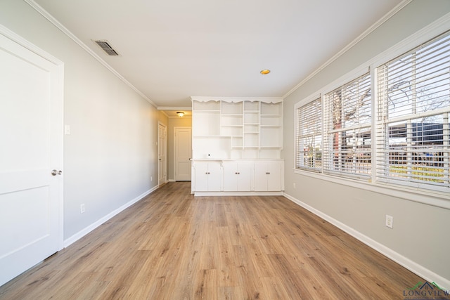 unfurnished bedroom featuring light wood-type flooring and ornamental molding