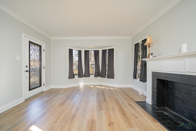 unfurnished living room with a tile fireplace, light hardwood / wood-style flooring, and ornamental molding