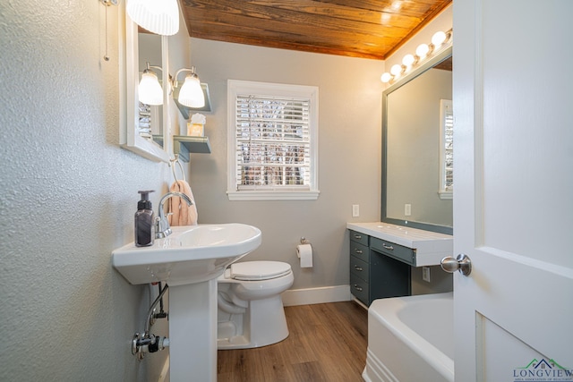 bathroom with sink, a bath, toilet, wood ceiling, and hardwood / wood-style flooring