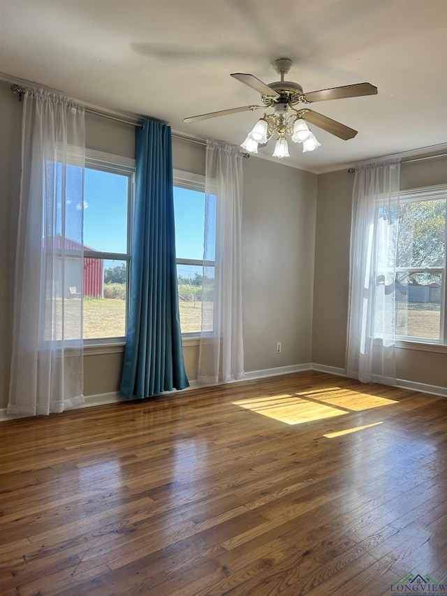 spare room with ceiling fan and dark wood-type flooring