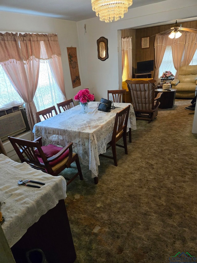 dining room featuring cooling unit, ceiling fan with notable chandelier, and dark carpet